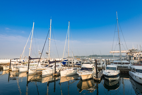 boats marina moored partly cloudy still waters