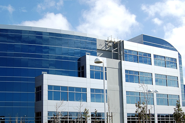 office building glass blue skies