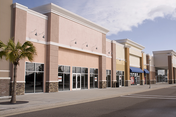 commercial building mall rows of stores windows doors lights