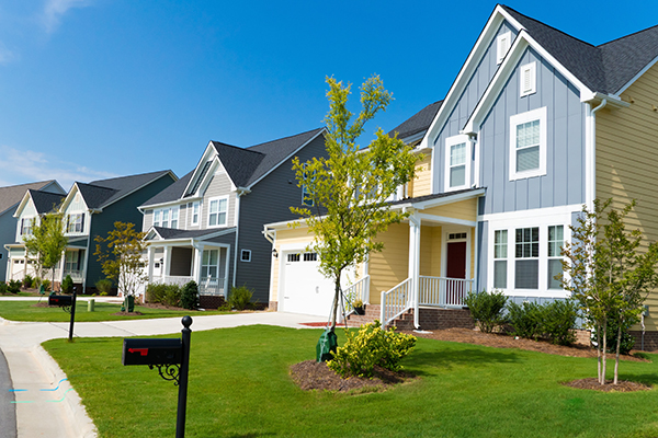 residential neighborhood mailbox green lawn steps covered porches steepled roof